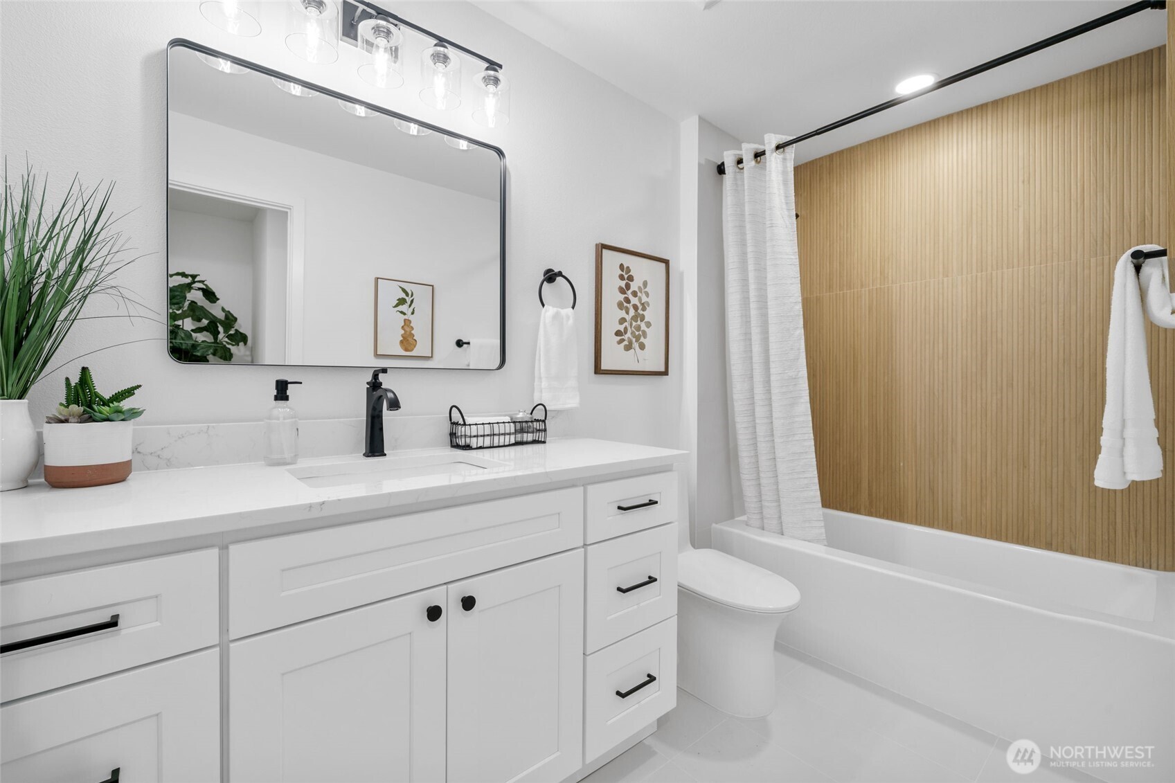 7004 16th Avenue Southwest Seattle, WA 98106 - Photo 16 of 37 a bathroom with a double vanity sink toilet mirror and shower