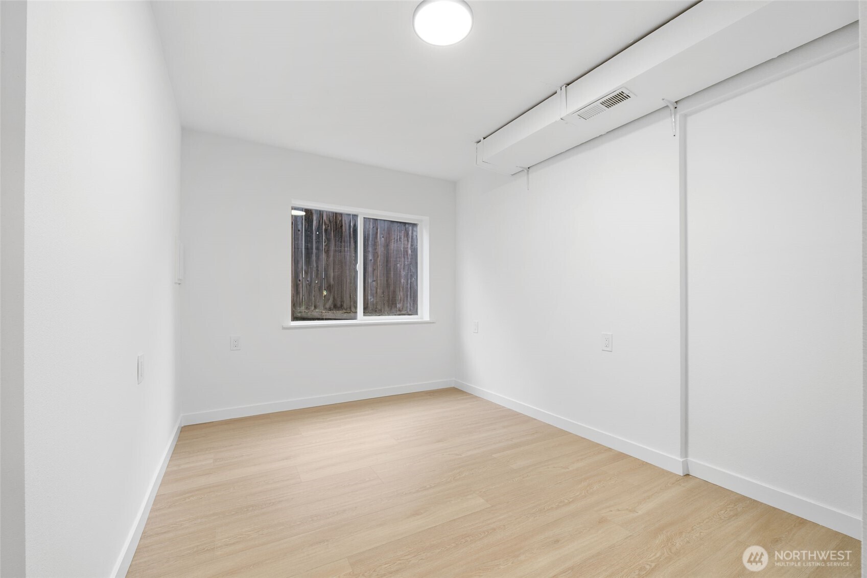 7004 16th Avenue Southwest Seattle, WA 98106 - Photo 27 of 37 a view of an empty room with windows