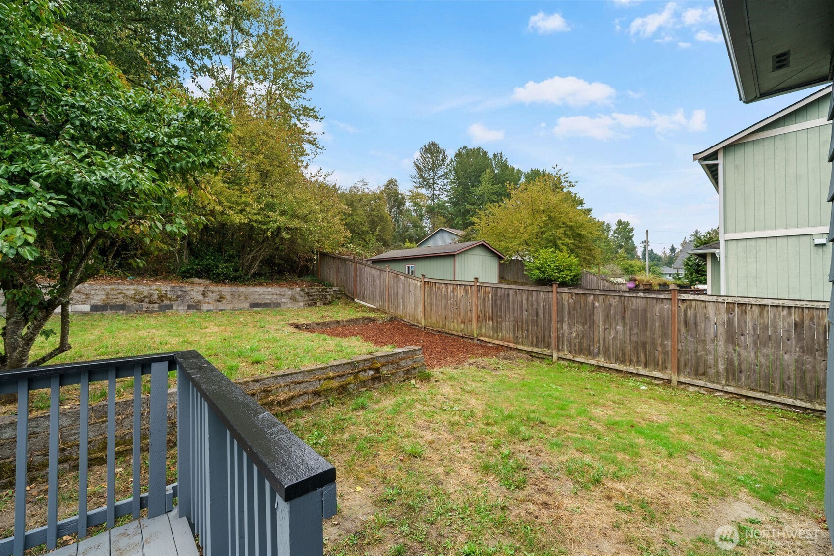 7004 16th Avenue Southwest Seattle, WA 98106 - Photo 33 of 37 a view of a backyard with wooden fence