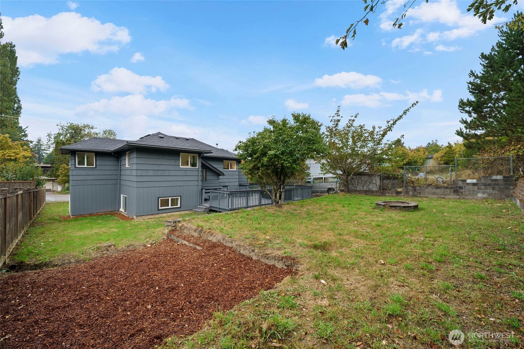 7004 16th Avenue Southwest Seattle, WA 98106 - Photo 34 of 37 a backyard of a house with lots of green space