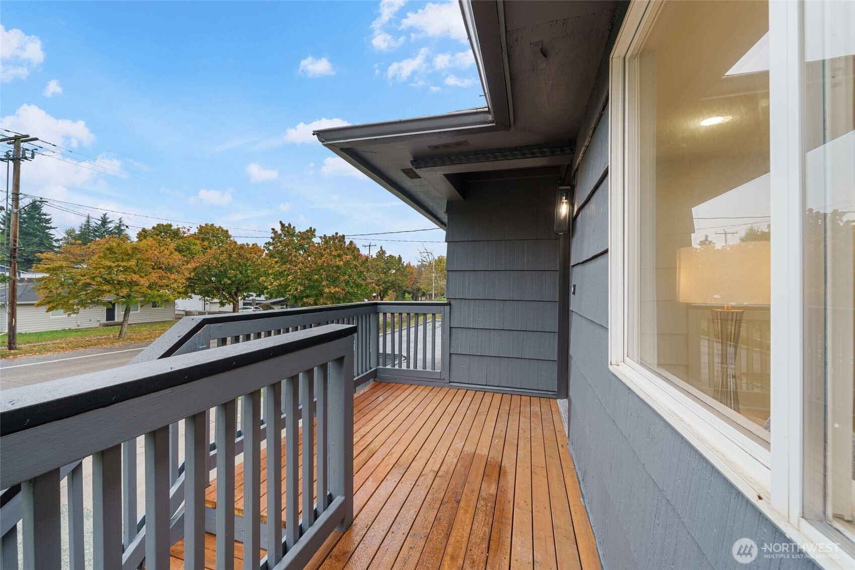 7004 16th Avenue Southwest Seattle, WA 98106 - Photo 4 of 37 a balcony with wooden floor and city view