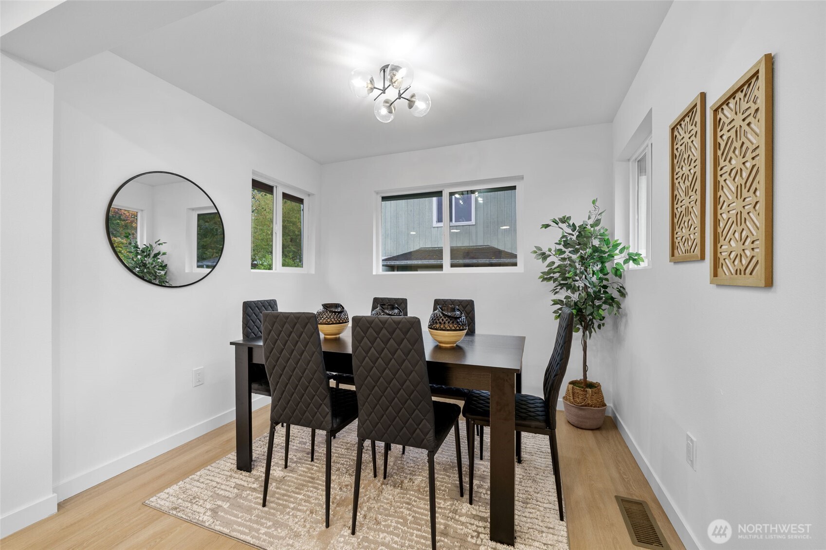 7004 16th Avenue Southwest Seattle, WA 98106 - Photo 10 of 37 a view of a dining room with furniture and a potted plant