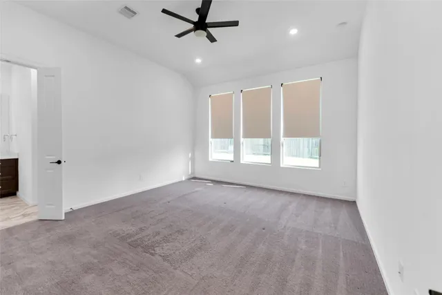 a view of a big room with wooden floor and windows
