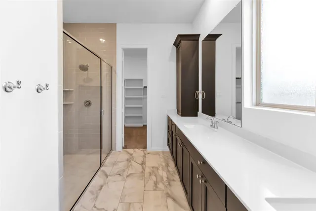 an empty room with a window and a view of a ceiling fan