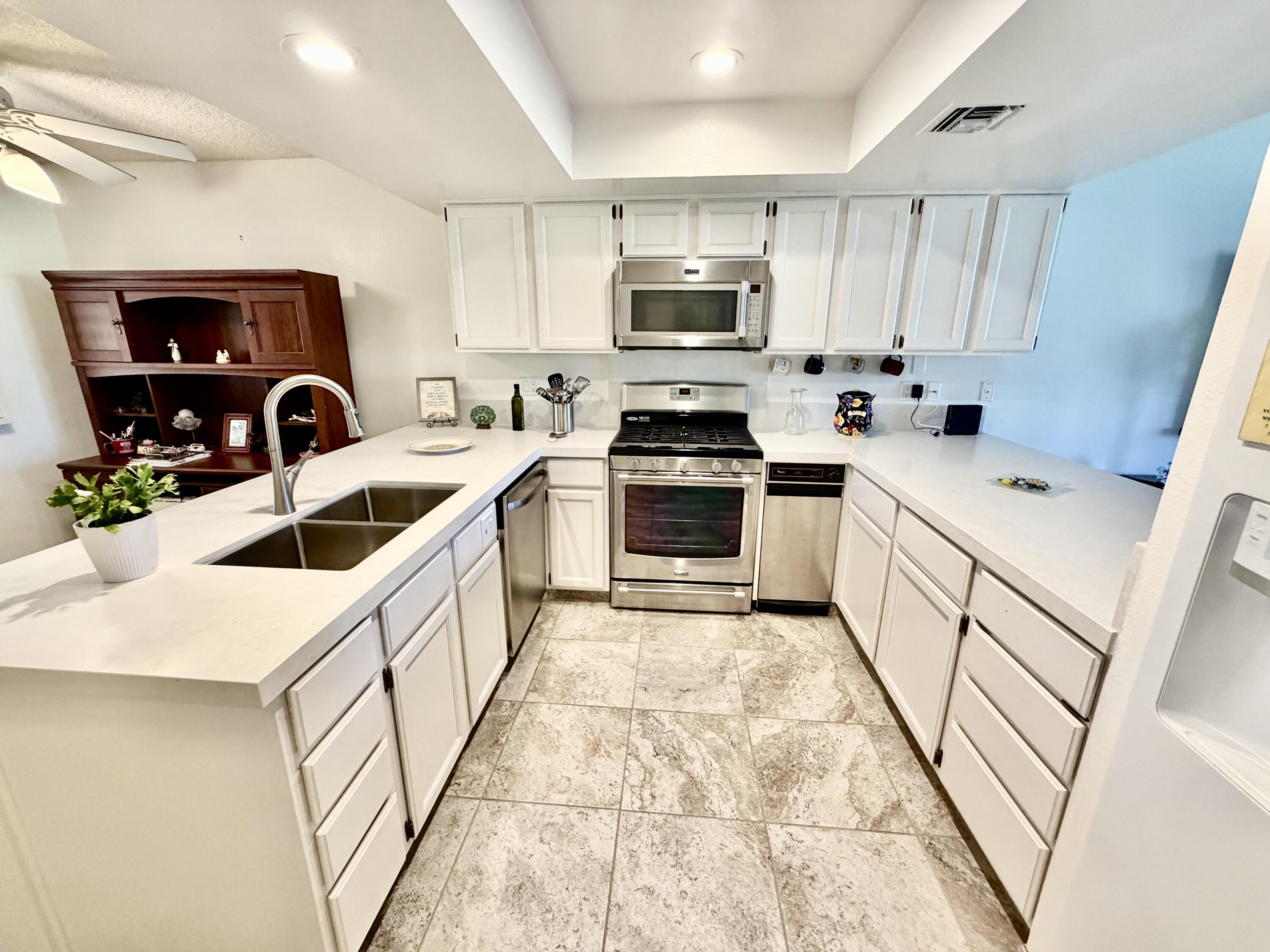 36 Mission Court Rancho Mirage, CA 92270 - Photo 2 of 17 a kitchen with granite countertop a sink a counter top space stainless steel appliances and cabinets