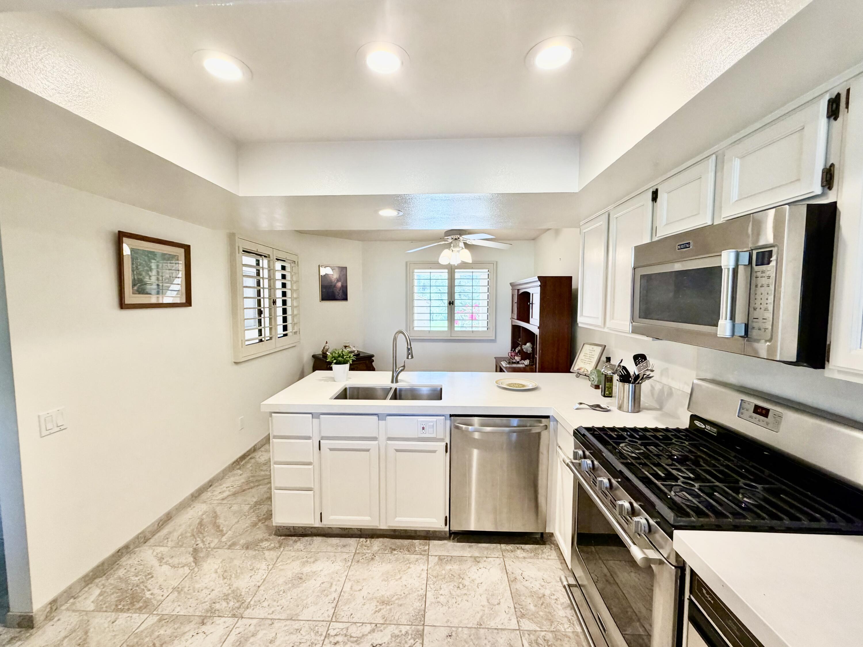 36 Mission Court Rancho Mirage, CA 92270 - Photo 3 of 17 a kitchen with a sink stove and microwave