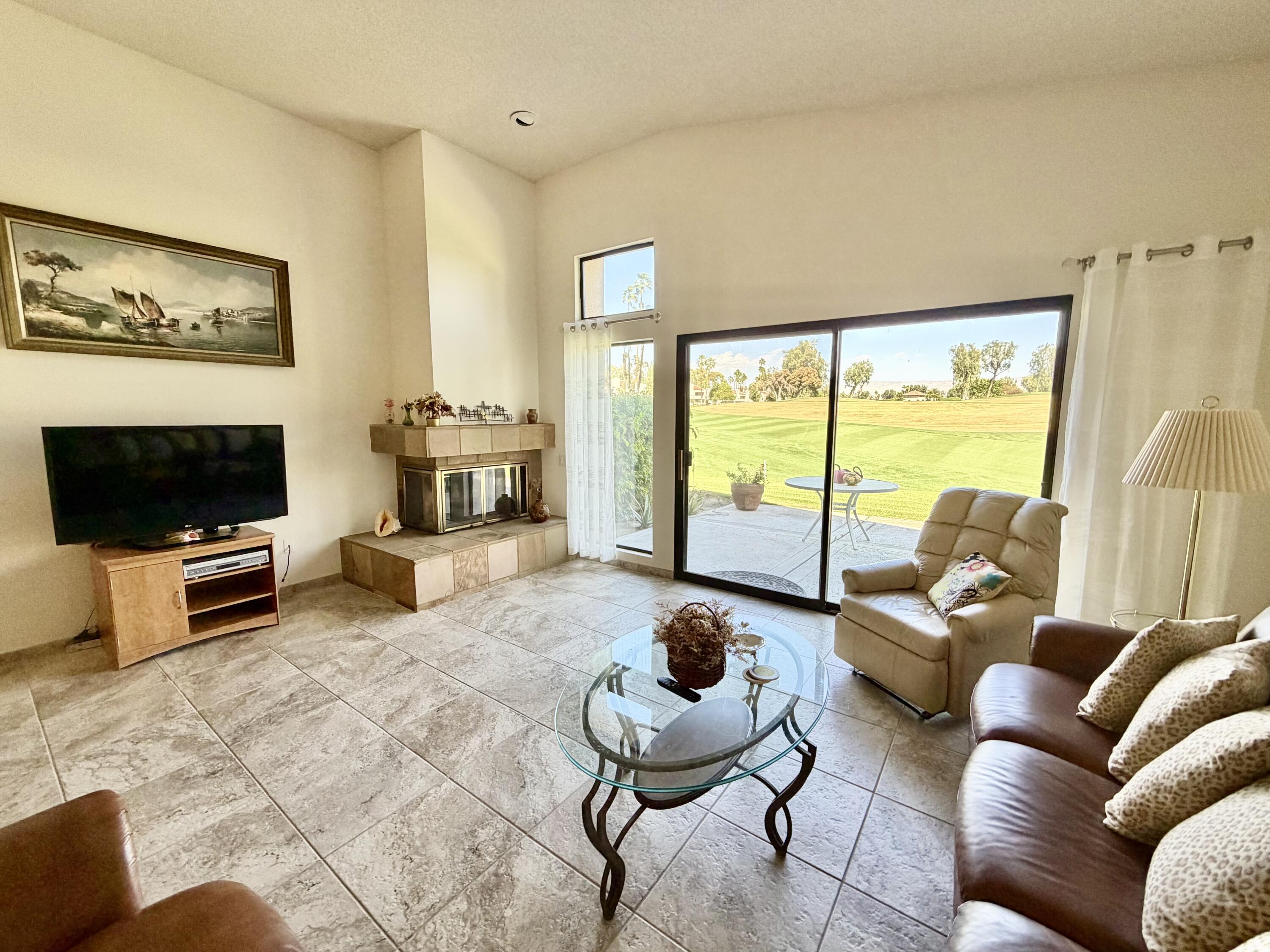 36 Mission Court Rancho Mirage, CA 92270 - Photo 4 of 17 a living room with furniture and a flat screen tv