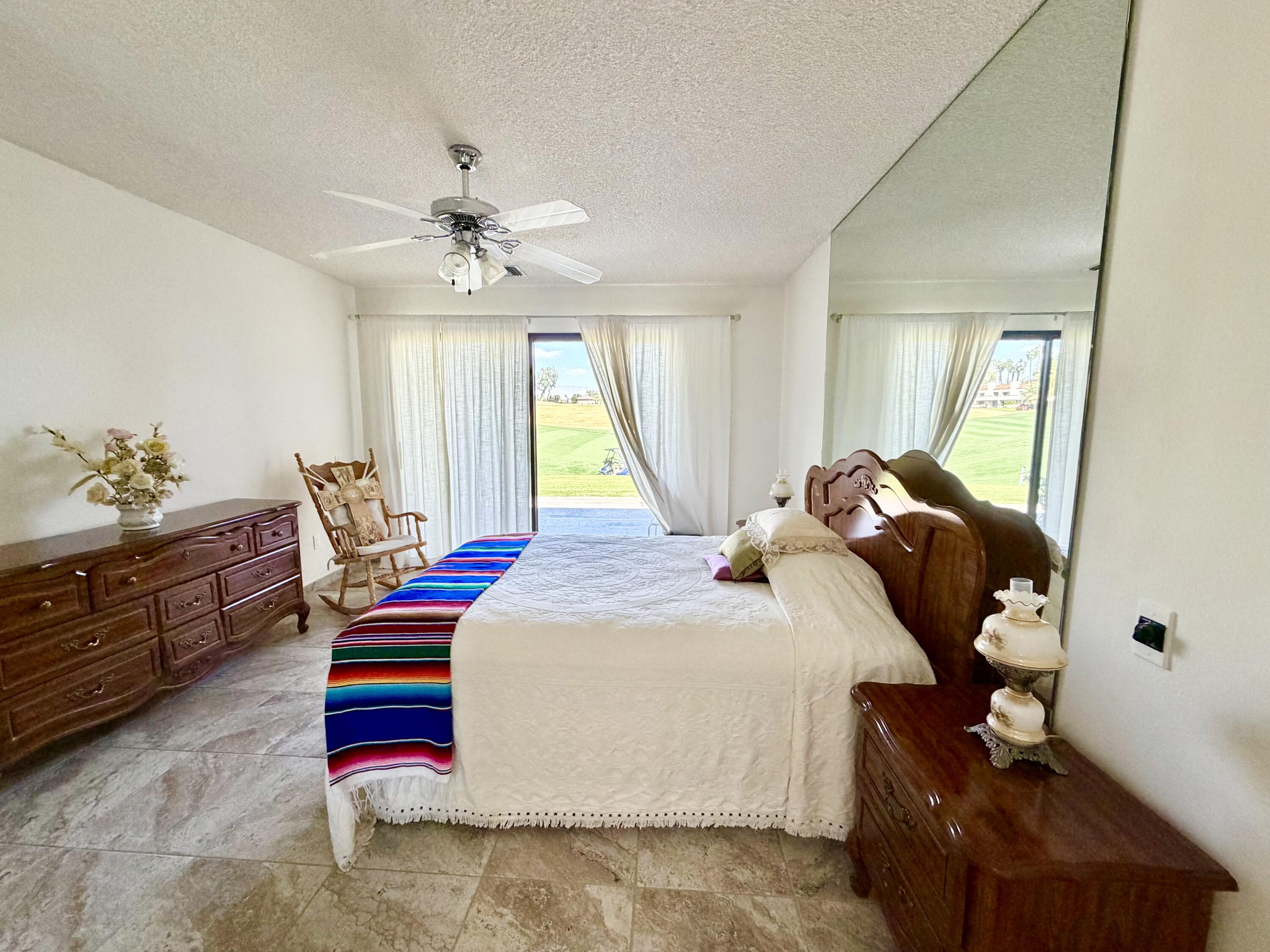 36 Mission Court Rancho Mirage, CA 92270 - Photo 5 of 17 a bedroom with a bed and window