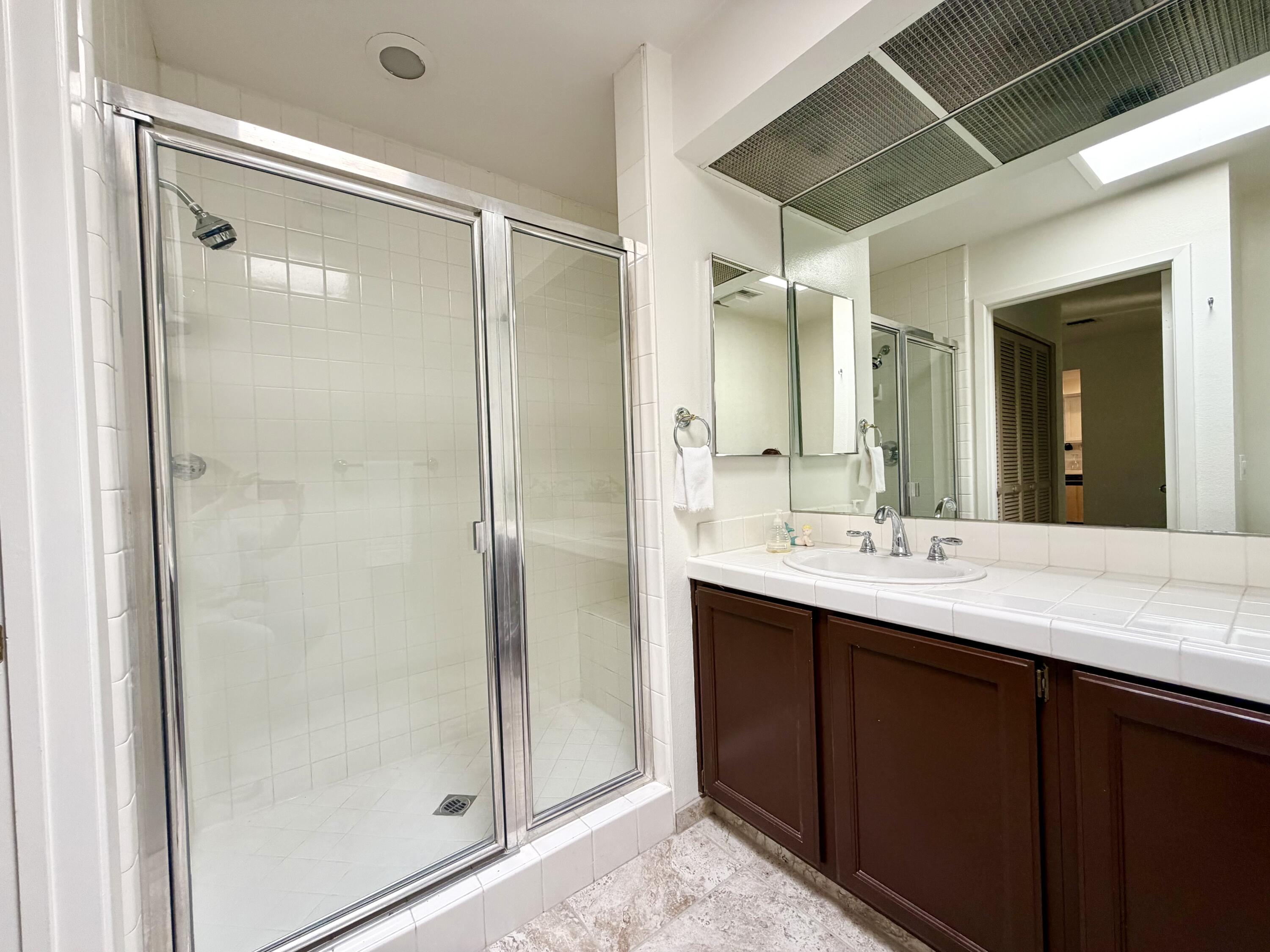 36 Mission Court Rancho Mirage, CA 92270 - Photo 6 of 17 a bathroom with a shower sink and mirror