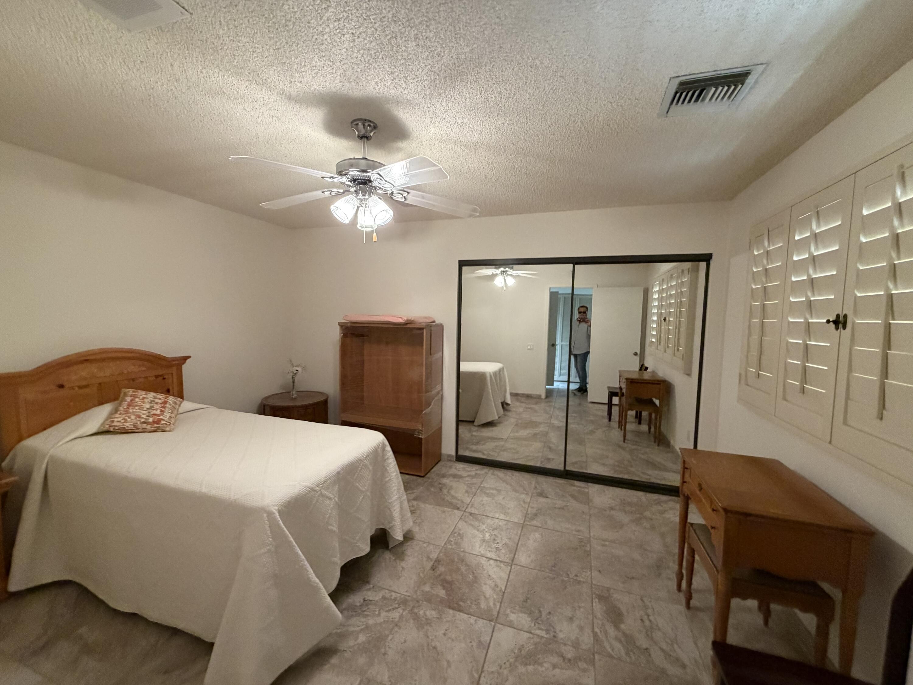 36 Mission Court Rancho Mirage, CA 92270 - Photo 7 of 17 a bedroom with a bed and a chandelier