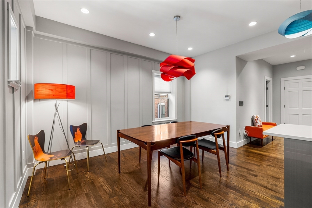 653 East 3rd Street Boston, MA 02127 - Photo 12 of 38 a dining room filled a chandelier a glass table and chairs