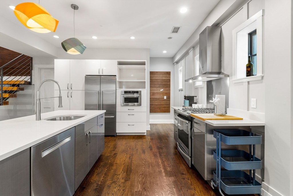653 East 3rd Street Boston, MA 02127 - Photo 14 of 38 a kitchen with stainless steel appliances granite countertop a sink and a refrigerator