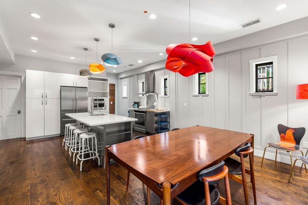 653 East 3rd Street Boston, MA 02127 - Photo 20 of 38 an open kitchen with dining table and chairs