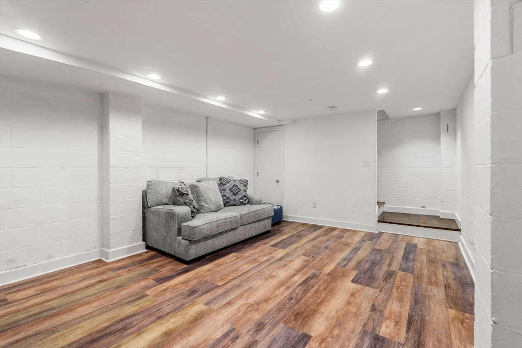 653 East 3rd Street Boston, MA 02127 - Photo 22 of 38 a living room with a couch and a wooden floor
