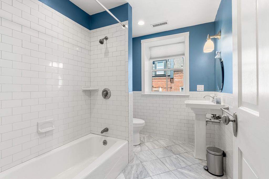 653 East 3rd Street Boston, MA 02127 - Photo 26 of 38 a bathroom with a bathtub and a shower