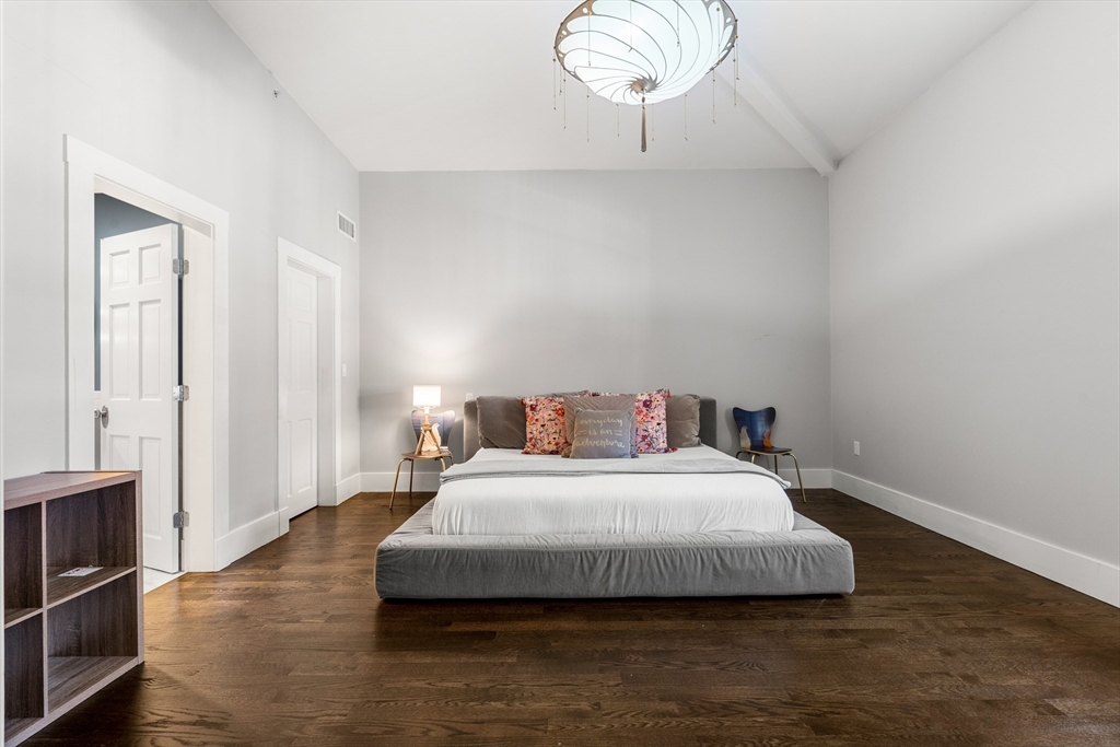 653 East 3rd Street Boston, MA 02127 - Photo 27 of 38 a bedroom with a bed and wooden floor