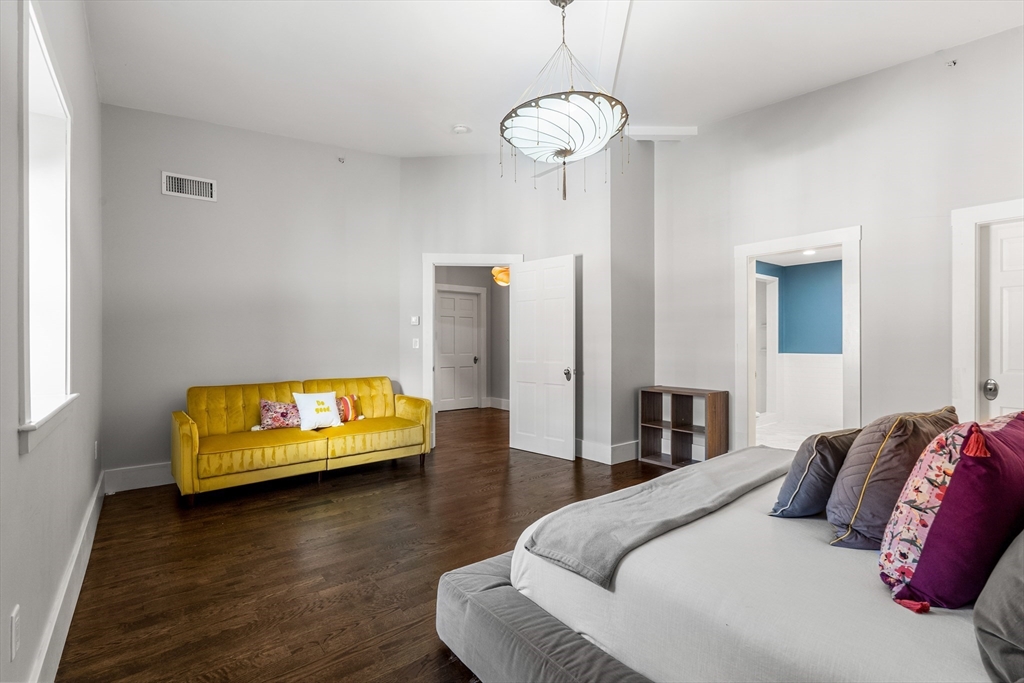 653 East 3rd Street Boston, MA 02127 - Photo 28 of 38 a bedroom with a bed and wooden floor