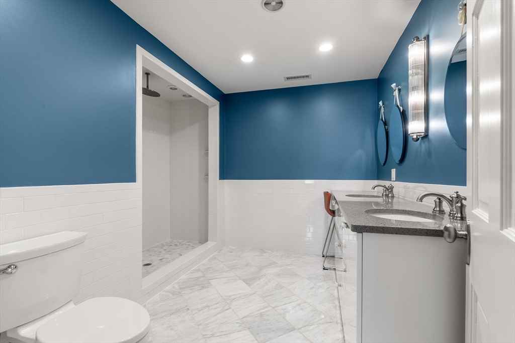 653 East 3rd Street Boston, MA 02127 - Photo 31 of 38 a bathroom with a sink a toilet and a mirror