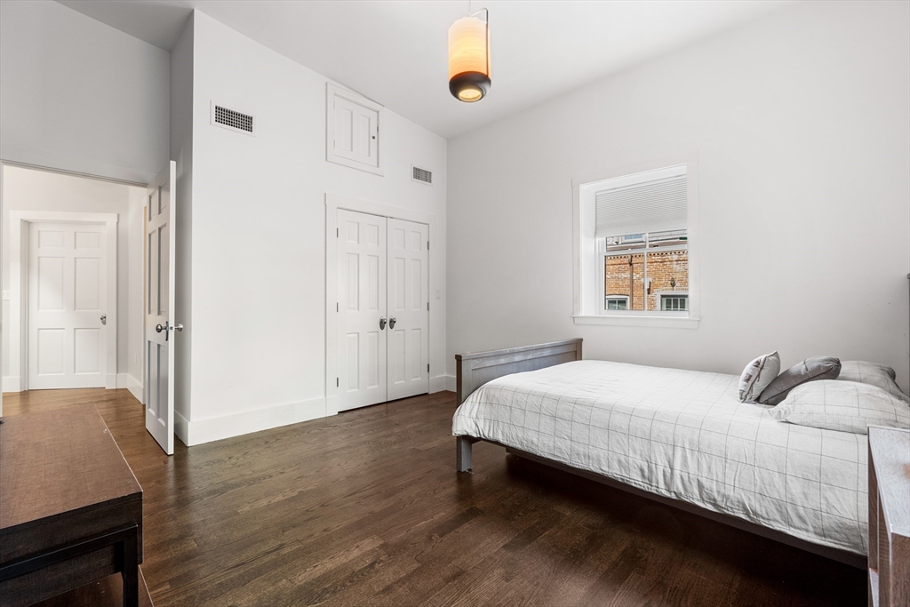 653 East 3rd Street Boston, MA 02127 - Photo 35 of 38 a bedroom with a bed and a window