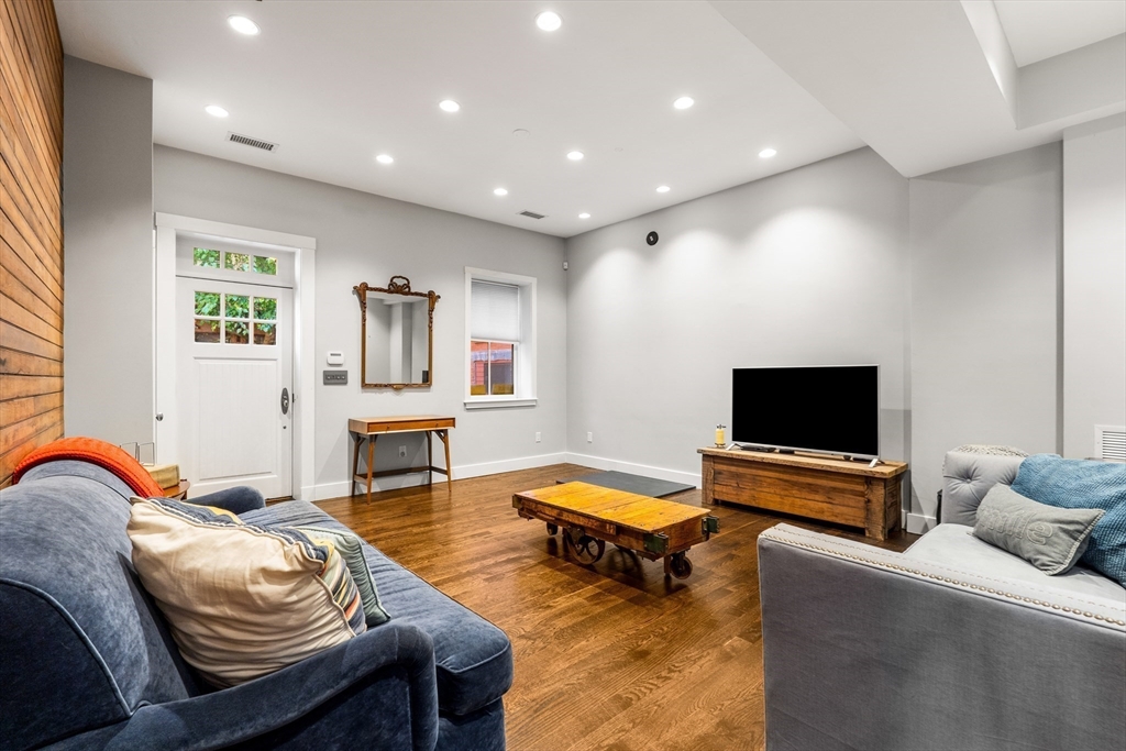 653 East 3rd Street Boston, MA 02127 - Photo 6 of 38 a living room with furniture and a flat screen tv
