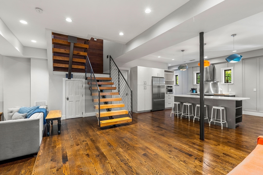 653 East 3rd Street Boston, MA 02127 - Photo 8 of 38 a view of a living room filled with furniture and wooden floor