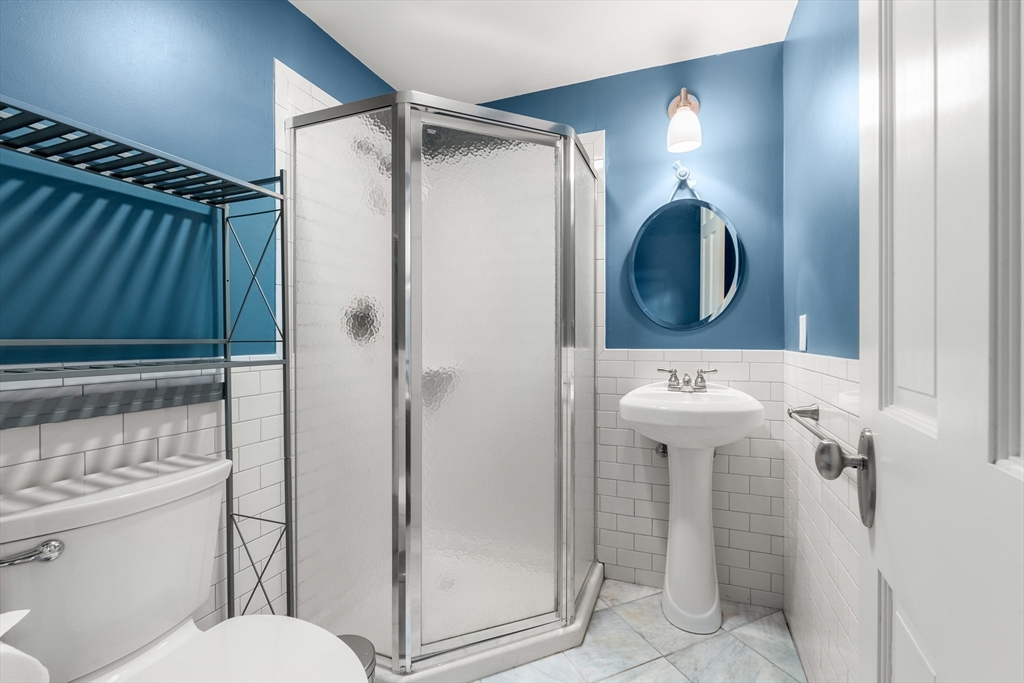 653 East 3rd Street Boston, MA 02127 - Photo 9 of 38 a bathroom with a sink toilet and shower
