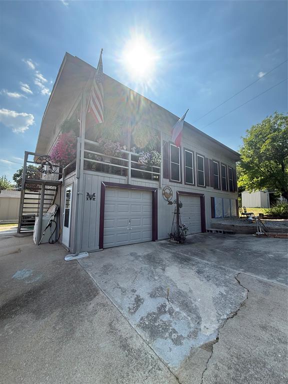 View of front of home with concrete driveway and an attached garage
