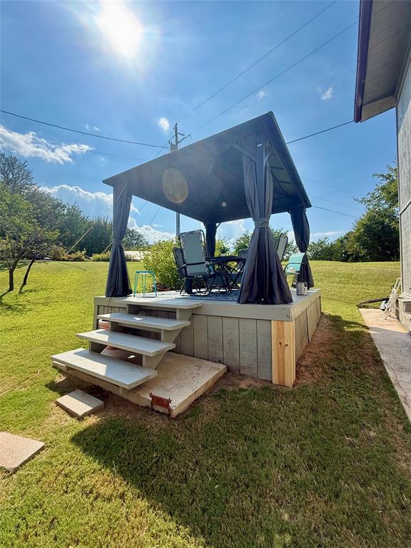 309 Broken Arrow Comanche, TX 76442 - Photo 25 of 33 Wooden terrace featuring a yard