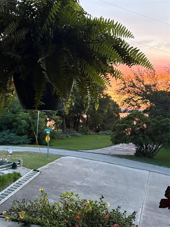 309 Broken Arrow Comanche, TX 76442 - Photo 29 of 33 Patio terrace at dusk featuring a yard