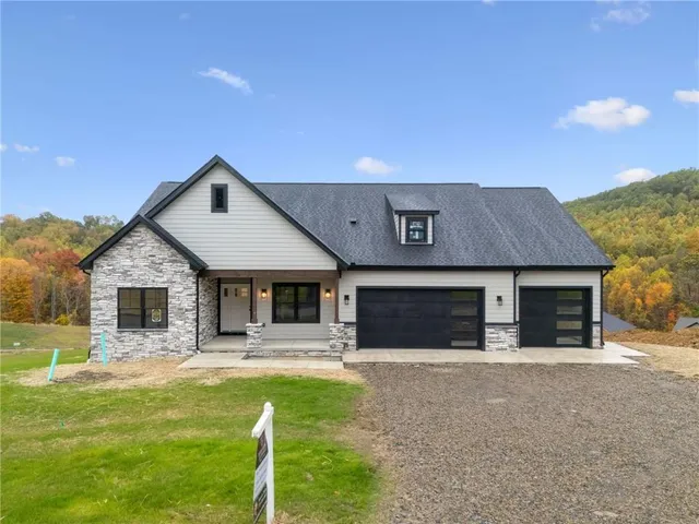 a front view of a house with swimming pool and a yard