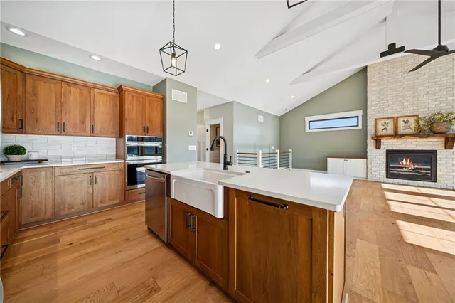 a kitchen with a sink counter top space cabinets and stainless steel appliances