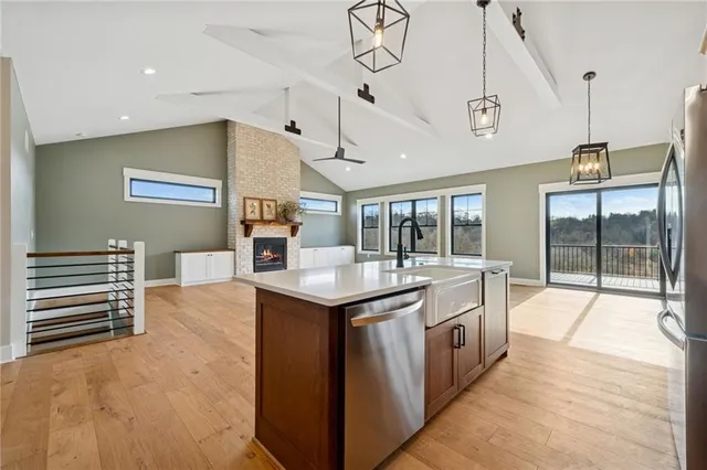 a kitchen with stainless steel appliances granite countertop a sink and cabinets