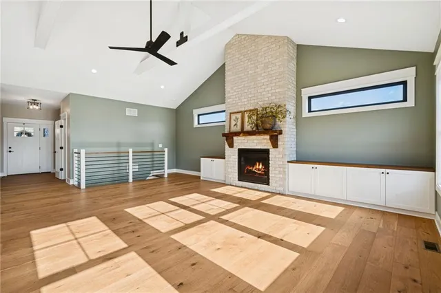 a view of livingroom with kitchen and dining area wooden floor