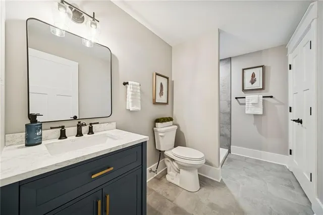 a bathroom with a sink toilet and shower