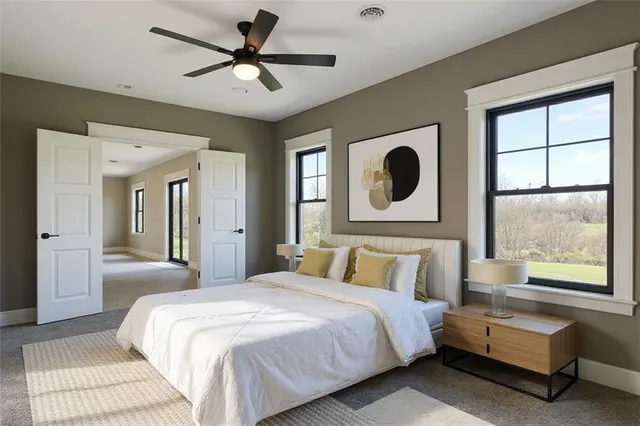 a bedroom with a large bed and a large window