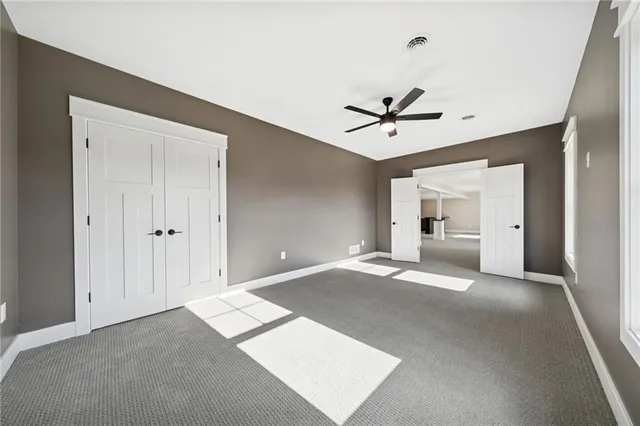 a living room with furniture and a ceiling fan