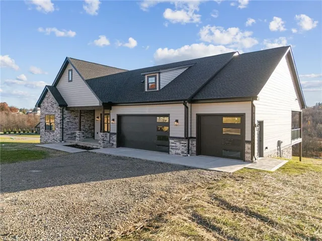 a view of a house with a patio and a yard