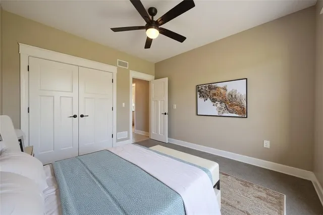 a bedroom with a large bed and a chandelier