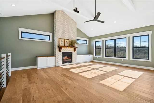 a view of an empty room with a fireplace and a window