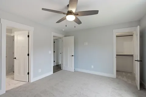 a view of an empty room with a ceiling fan