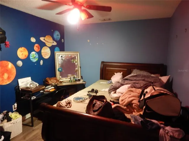 a bedroom with a bed and lamp