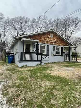 a front view of a house with a yard table and chairs
