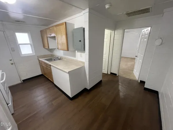 a kitchen with a sink a refrigerator and a stove