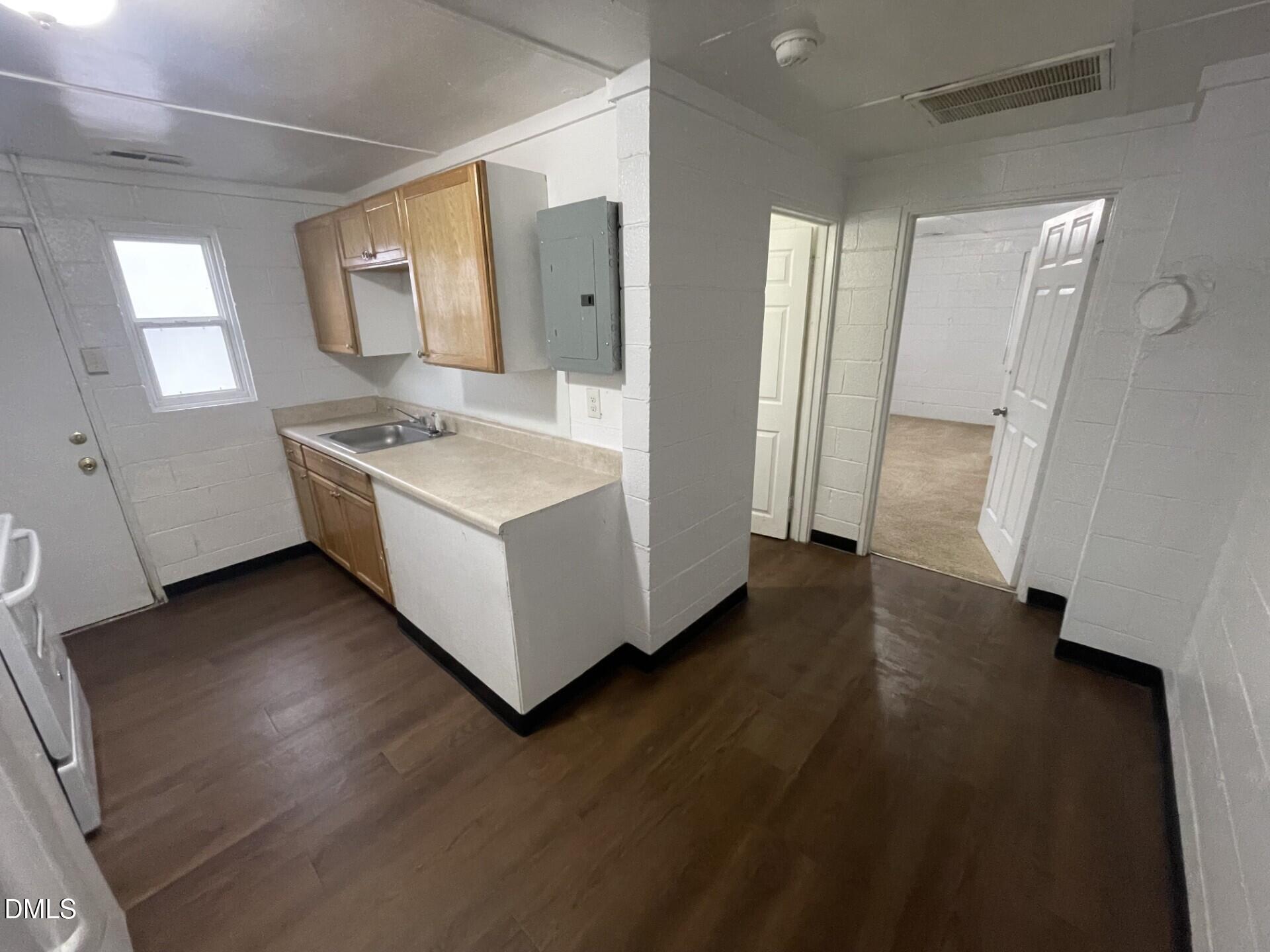 820 Coleman Street, Unit 1/2 Raleigh, NC 27610 - Photo 4 of 8 a kitchen with a sink a refrigerator and a stove