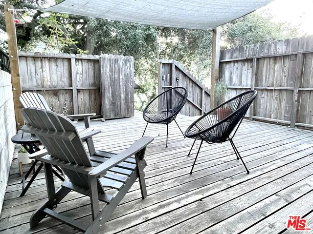 a view of a wooden chairs on roof deck