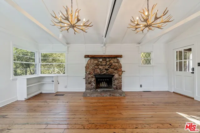 a view of living room with furniture and a fireplace