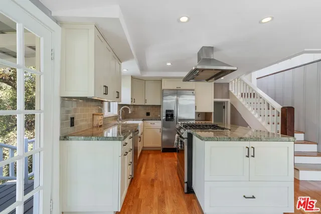 a kitchen with a stove a refrigerator and a sink