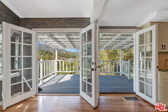 a view of a balcony with wooden floor