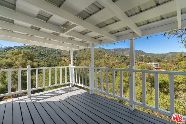 a view of a balcony with wooden floor
