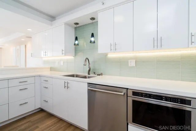 a kitchen with a sink stove and cabinets